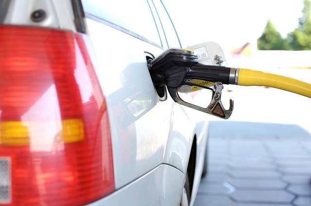 a white car being refilled at a petrol station